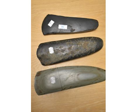 Three Oceanic stone axe heads, of Papua New Guinea origin, the largest measures 25cm long