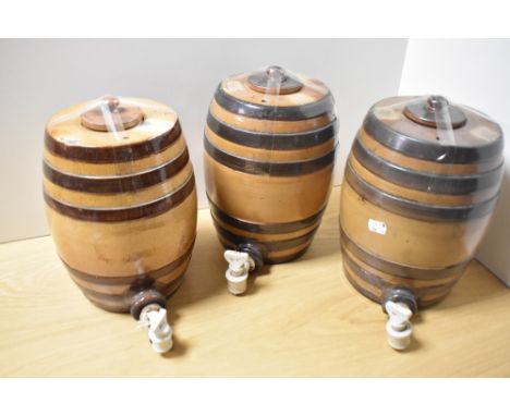 A group of three 19th Century Doulton Lambeth salt glazed spirit barrels, each with ceramic spiggots, measuring 26cm tall