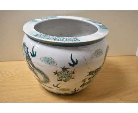 A 20th Century Chinese porcelain jardiniere, decorated in shades of green and gilt, illustrating the dragon and pearl, measur