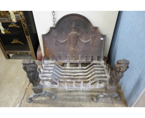 A cast iron fire grate and andirons