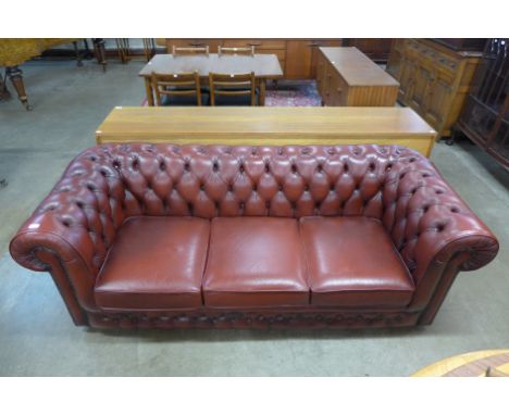 A red leather Chesterfield settee