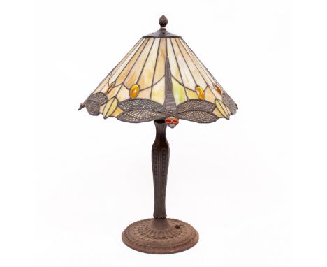 A CAST METAL BASED TABLE LAMP with a leaded glass Tiffany style lamp shade, decorated with dragonflies, the shade 37cm wide, 