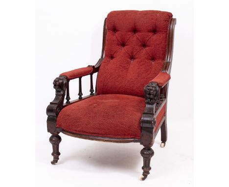 A VICTORIAN GENTLEMAN'S ARMCHAIR with a button upholstered back and upholstered seat, carved lion's mask handles, turned feet