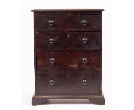 A 20TH CENTURY MAHOGANY APPRENTICE TABLETOP CHEST of four graduated drawers with turned handles standing on bracket feet 32cm