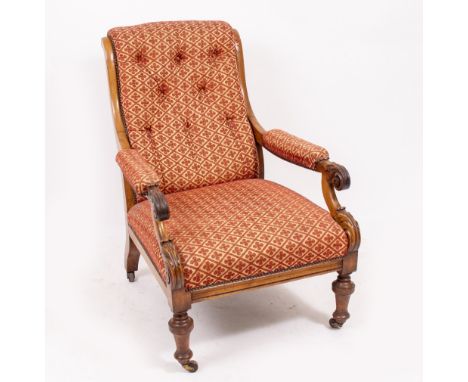 A VICTORIAN WALNUT FRAMED ARMCHAIR with a button upholstered back and upholstered seat, scrolling acanthus leaf arms with tur