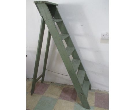 A vintage green painted wooden step ladder