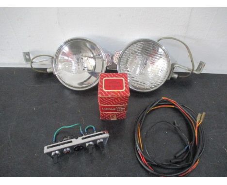 A vintage chrome Lucas car spotlight and fog light along with switches etc. circa 1965