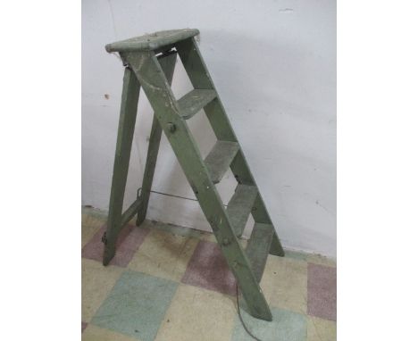 A vintage green painted wooden step ladder