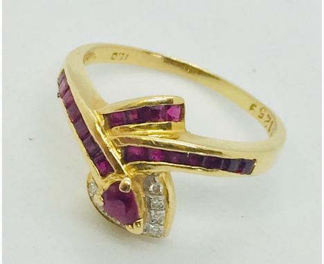 A ruby and diamond snake ring set in 18ct gold.