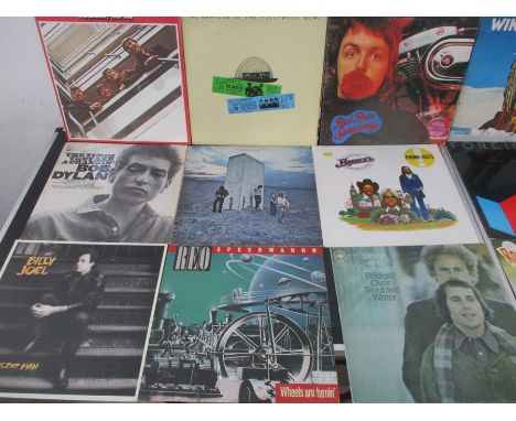 A collection of 12" vinyl records including The Beatles, The Who, Simon &amp; Garfunkel, Beach Boys, Rolling Stones, Foreigne