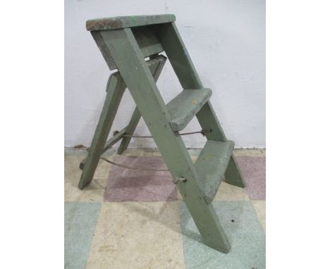 A small vintage wooden green painted step ladder