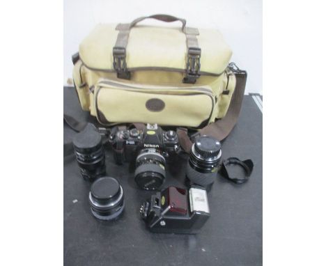 A Nikon F-301 camera along with 3 lenses including Sigma and Hoya etc.