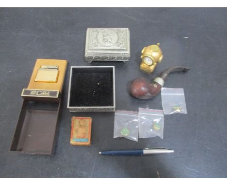 A small collection of interesting items including a Colibri lighter, playing cards, pipe, pin badges, pen etc