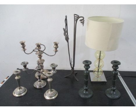 A silver plated candleabra along with various candlesticks, light etc.