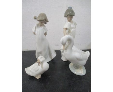 Two Nao figurines of girls, along with two Nao geese.