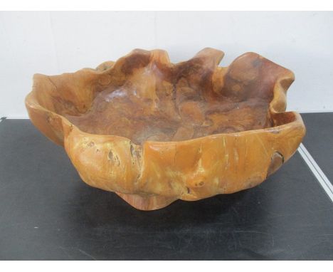 A wooden bowl formed from a tree trunk
