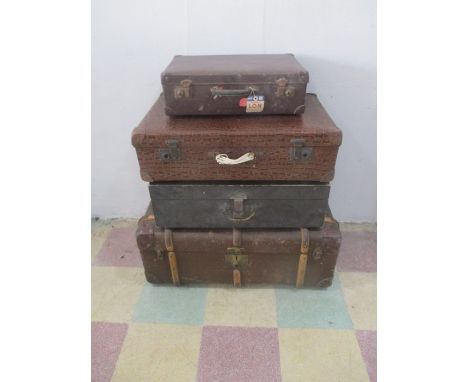 A collection of three vintage suitcases, along with a T.Howie trunk