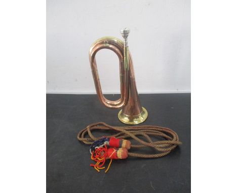 A copper and brass bugle marked Vincent Bach Corp. 7CFL