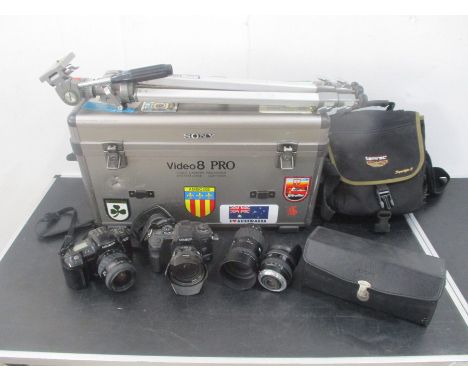 Two Minolta camera's along with three separate lens including a cased Sigma AF Tele. Also including is a carry case, tripod, 