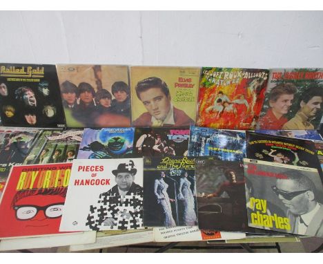 A collection of 12" vinyl records including The Kinks, The Beatles, The Rolling Stones, Cliff Richard, Elton John, Elvis Pres