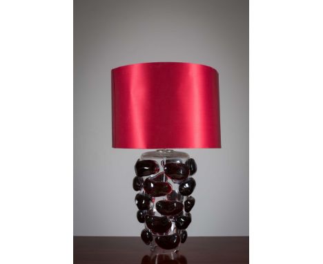 A GLASS TABLE LAMP, CONTEMORARY, the molded glass base, with red shade, 80cm (h)