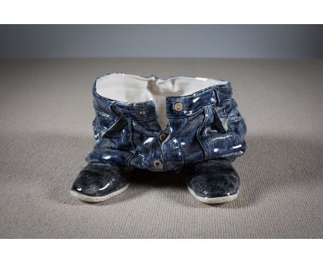 A CERAMIC PLANTER IN THE FORM OF TROUSERS AND SHOES, by Ian Wright, 31 cm (w) x 20cm (h).