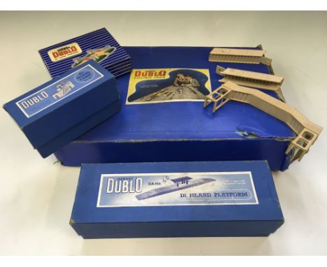 A collection of Hornby Dublo, including electric train set, signal cabin, island platform, and other parts.