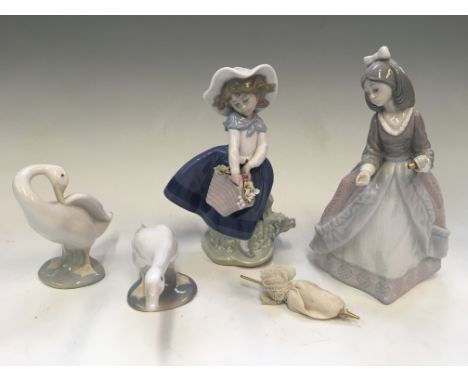 Four Lladro figurines, two ducks, girl with flowers and girl with umbrella.