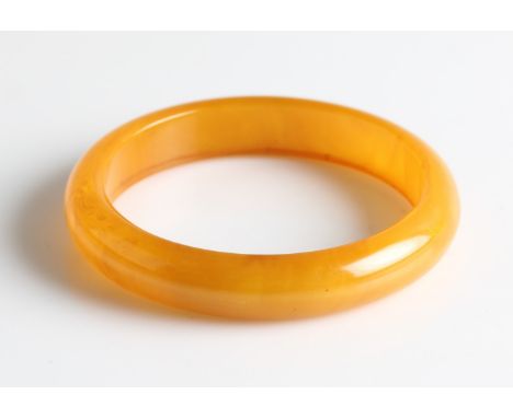A Bakelite butterscotch amber-coloured bangle.