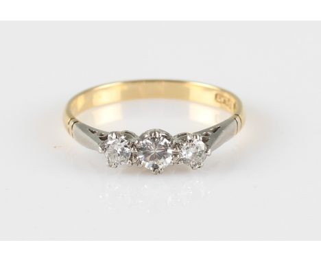 A three stone diamond ring, set with three graduated round brilliant cut diamonds, total diamond weight approx. 0.40ct, stamp