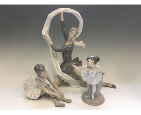 Three Nao dancer figurines, one with veil, one seated slipper ballerina and one my first bow.