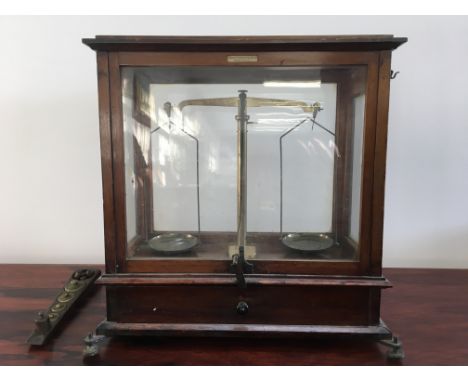 A Philip Harris &amp; Co Birmingham mahogany and glass cased set of scales, with set of weights.