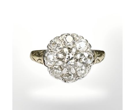 An 18ct gold and platinum cluster ring, with nine old-cut stones in claw settings, the total diamond weight estimated at 1.68