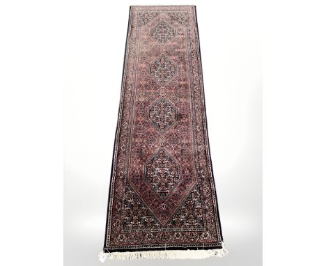 A Tabriz runner, 242cm by 73cm