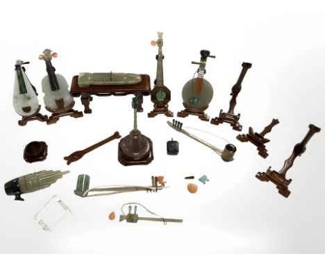 A group of Chinese polished jade or similar hard stone miniature musical instruments (losses)