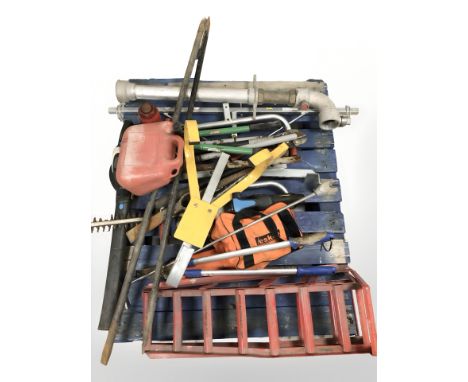 A pallet of hand tools, strimmer, car ramps and other hard ware 