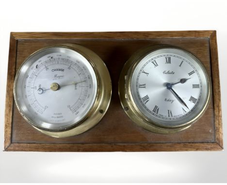 A brass cased barometer and eight day timepiece mounted on board, width 26 cm.