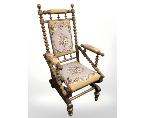A continental oak bobbin turned rocking chair in tapestry fabric 