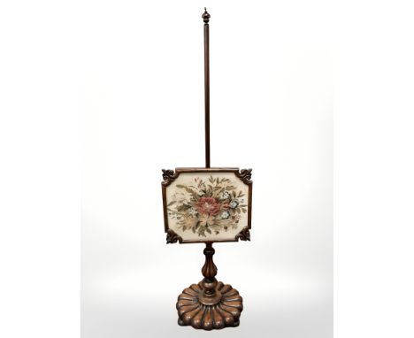 An early Victorian mahogany tapestry pole screen.