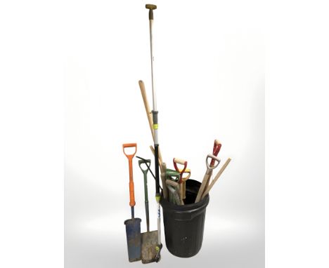 A plastic bucket of garden tools 