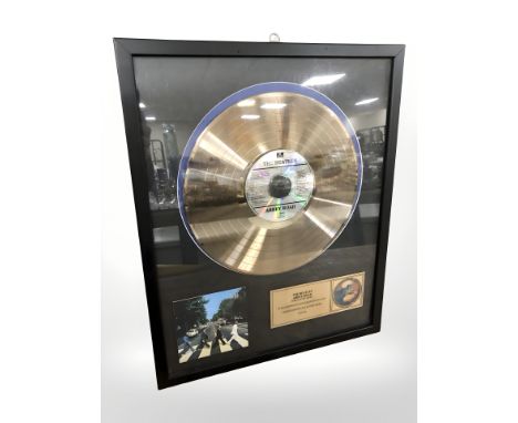 A The Beatles Abbey Road gold plated vinyl disc, numbered 20 of 40, 54 cm x 44 cm.