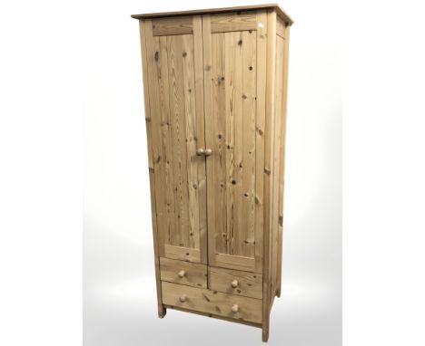 A modern pine double door wardrobe, 75 cm W x 53 cm D x 180 cm H.