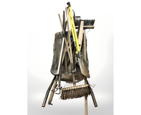 A wheel barrow containing garden tools 