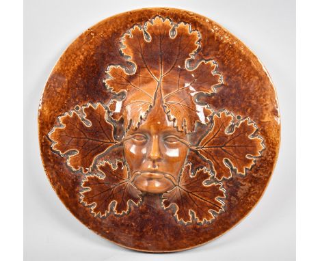 A Large Treacle Glazed Ceramic Circular Wall Hanging, Maiden and Vine Leaves, 42cm Diameter, Some Condition Issues to Inner R