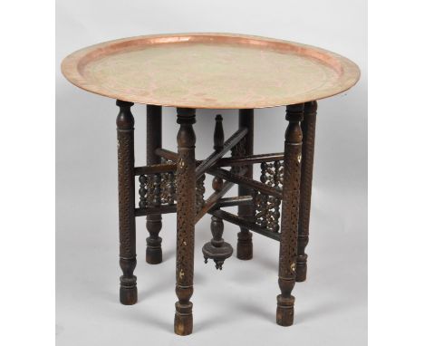 A Benares Copper Tray on Carved and Pierced Folding Stand, 61cm Diameter 