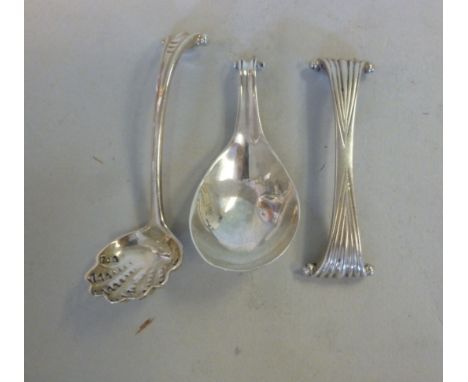 George III white coloured metal Onslow pattern white coloured metal, viz. a caddy spoon, a sifter spoon and a knife rest 