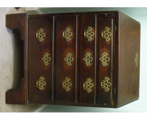 A George III mahogany bureau, the fall front enclosing a door, two drawer and pigeon holes, over four graduated long drawers 