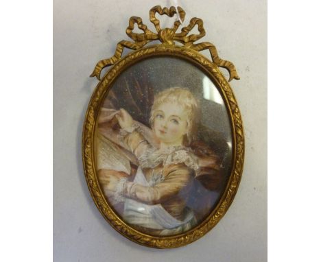 A late 19thC half-length oval portrait miniature, a blonde haired boy, wearing a brown jacket with lace cuffs, collar and whi