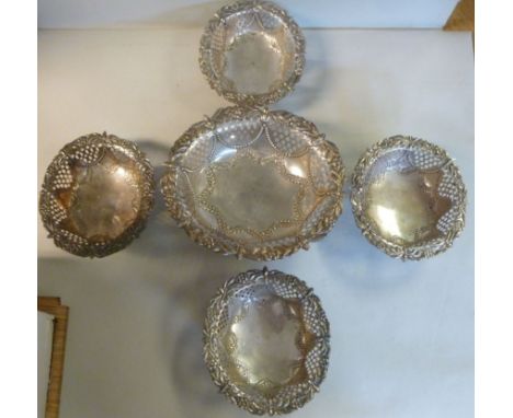 A late Victorian silver bowl of oval, pierced form, the rim embossed with flowerheads and palm leaves, on a pedestal foot  8'