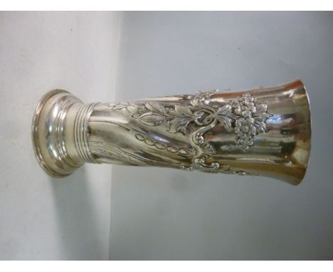 A late Victorian silver vase of tapered cylindrical form, embossed with swags, scrolls and flowerheads  Daniel & John Welby  